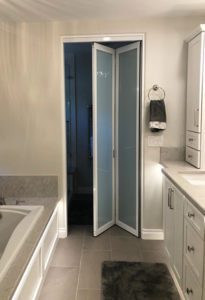 Bathroom bi fold white frame glass doors