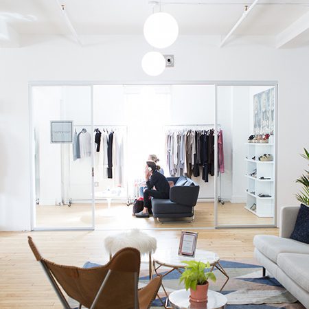 People sit on couch at retail store next to door room dividerr