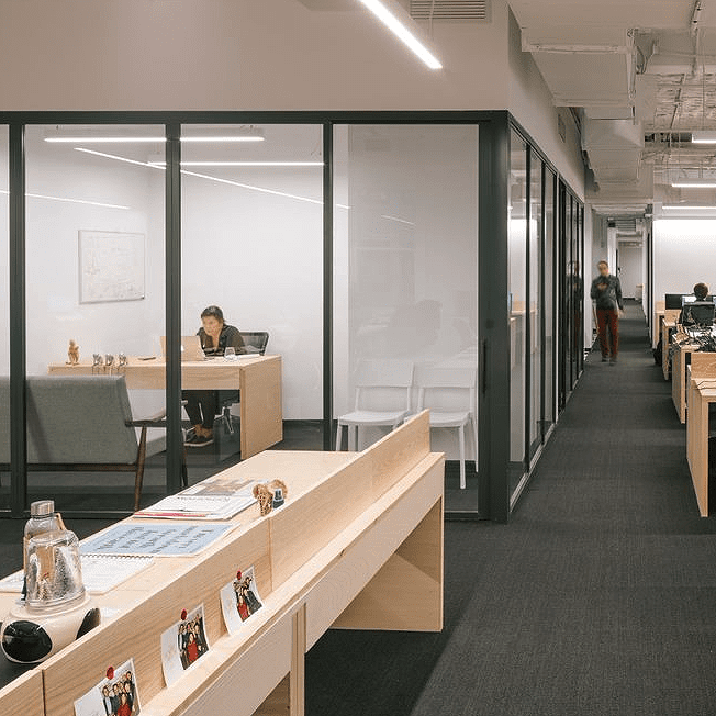 Corporate office meeting room space separated with clear glass fixed panel and sliding door
