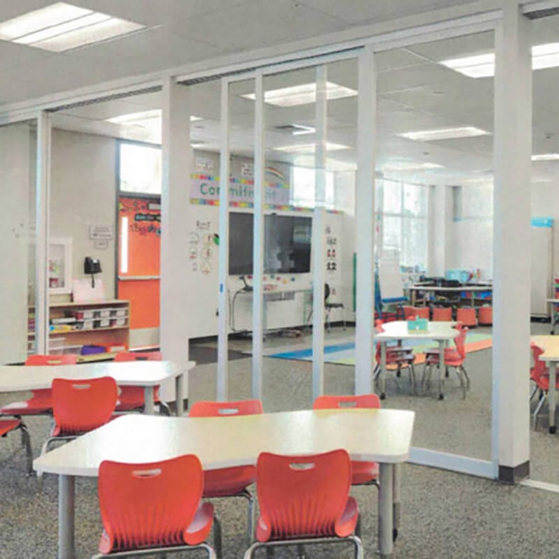 Clear glass PARTITION WALLS and sliding door divides children classroom area