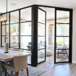 Living space with table and chairs glass room divider with swing doors
