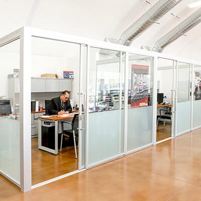 Person is working in modern office divided with glass sliding doors