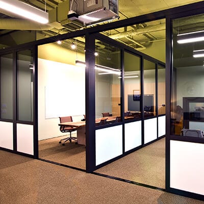 Corporate modern office area divided by glass room dividers