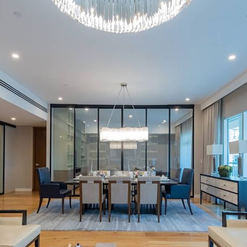 Set table with chairs next to glass fixed panel