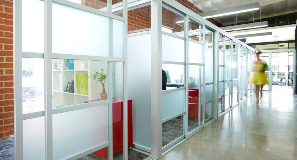 Glass sliding room dividers creating offices