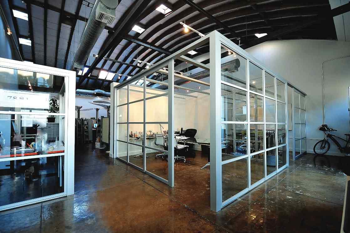 Office workspace with sliding glass doors and glass walls