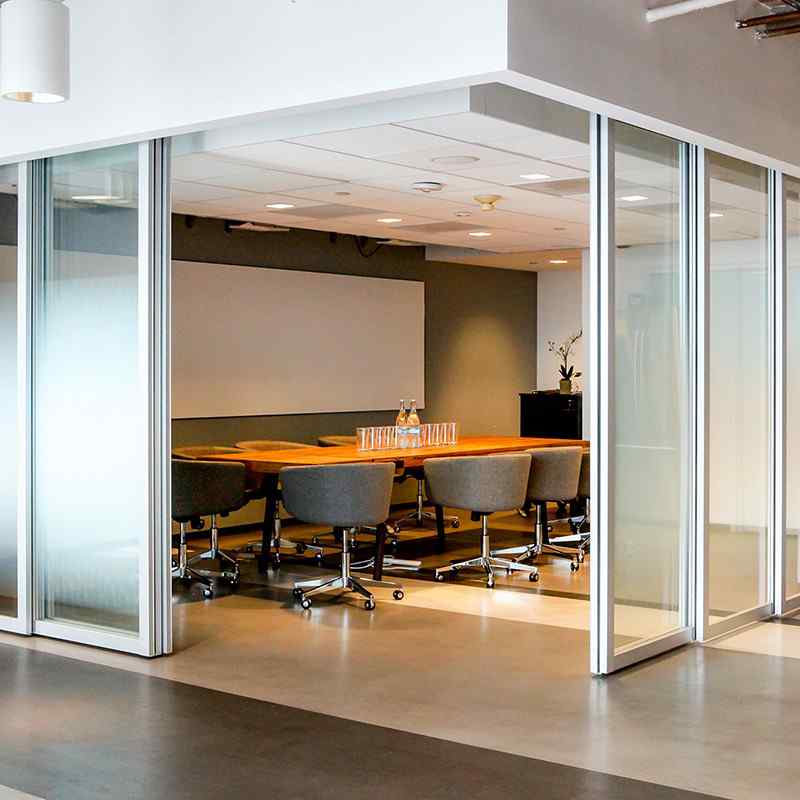 Office conference room with suspended sliding glass doors with c