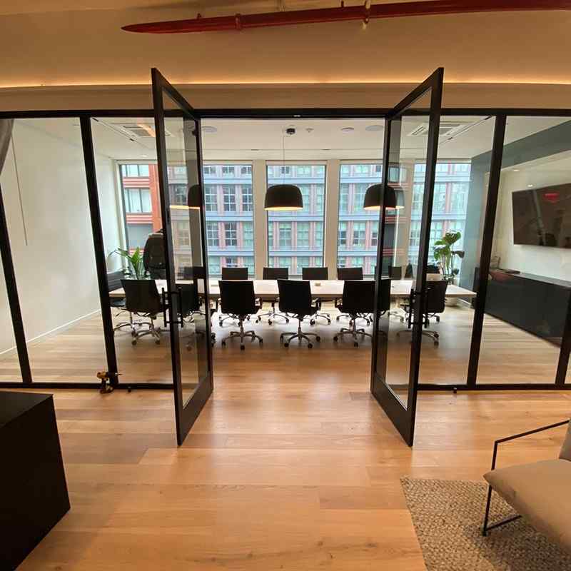 conference room with clear glass walls and clear swing doors