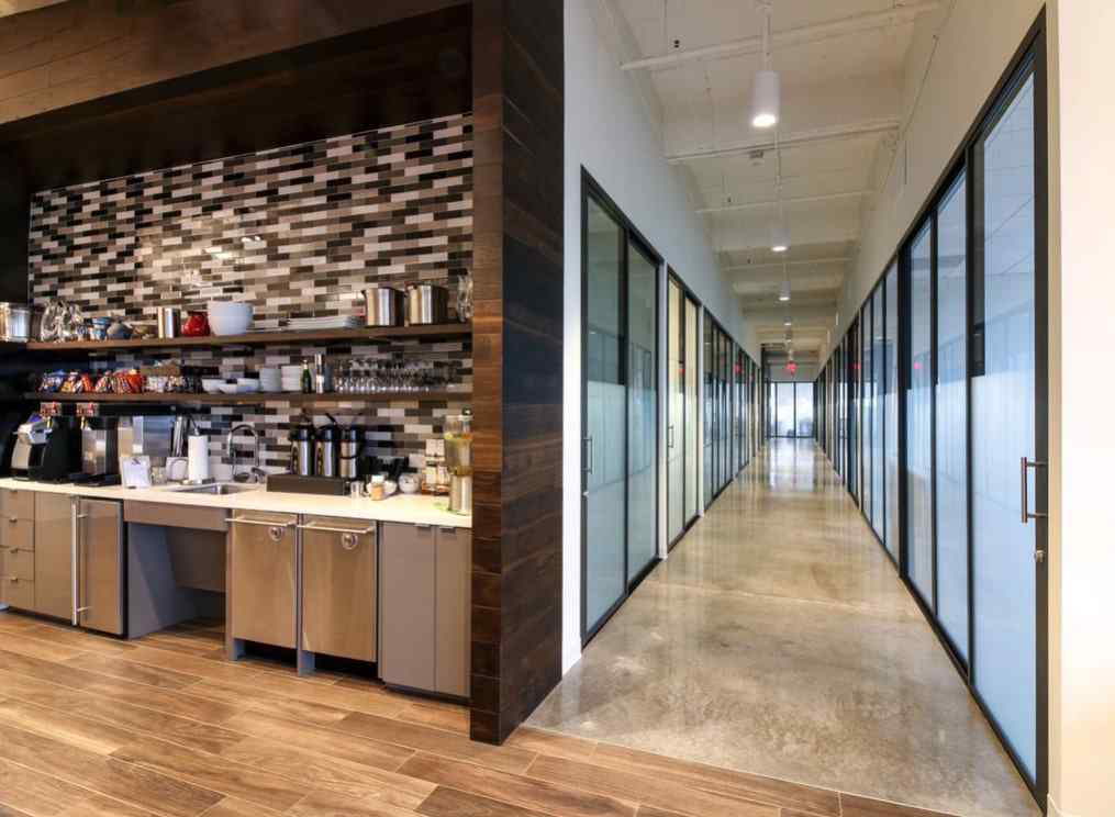 corporate hallway of offices with glass panels and doors