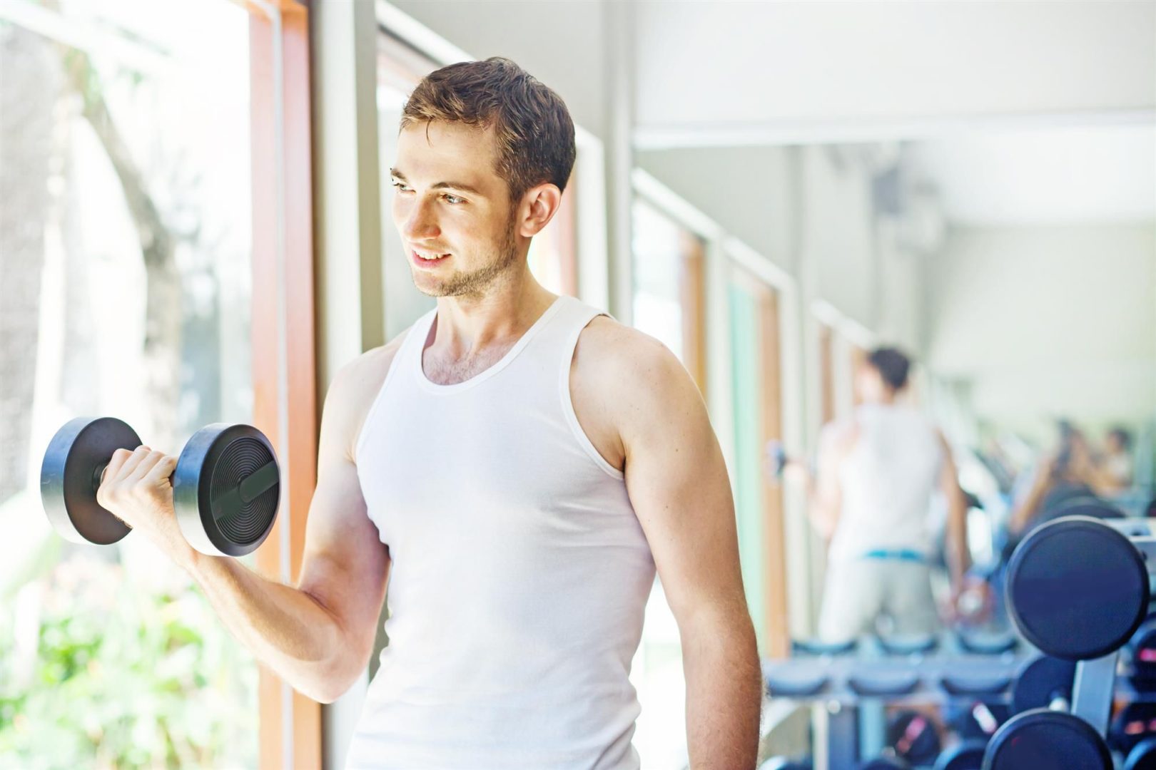 man lifting dumbbell