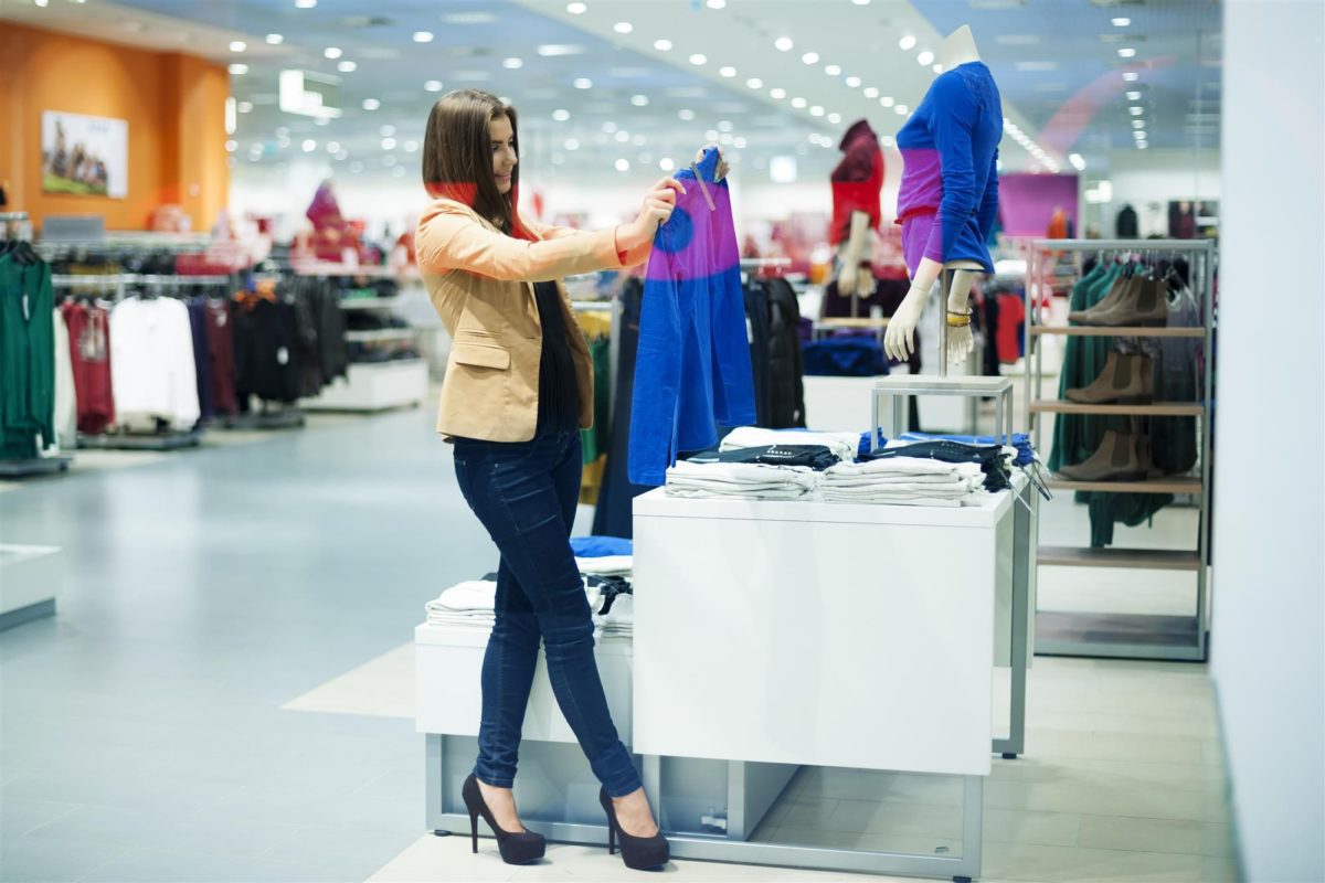 woman choosing cloths in shop